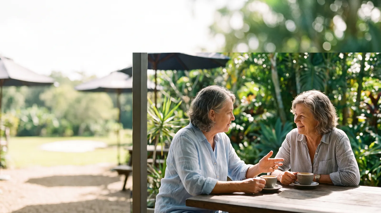 Two friends sharing a warm, unhurried conversation over coffee in Rockhampton